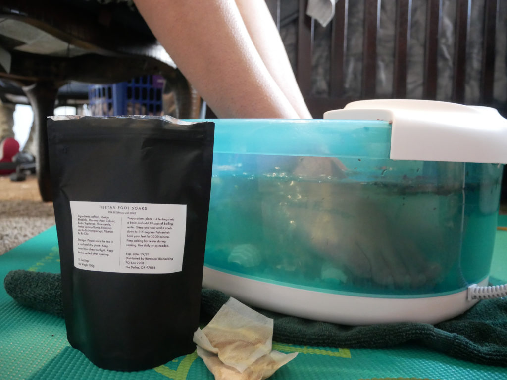 Woman foot soaking with tibetan foot soaks