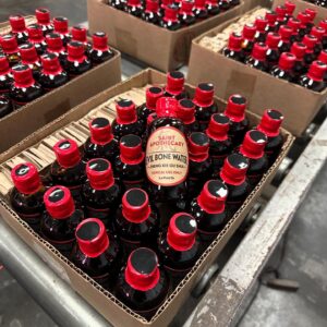 Mulitiple Boxes of Whole Sale Evil Bone Water in assemblily Line.